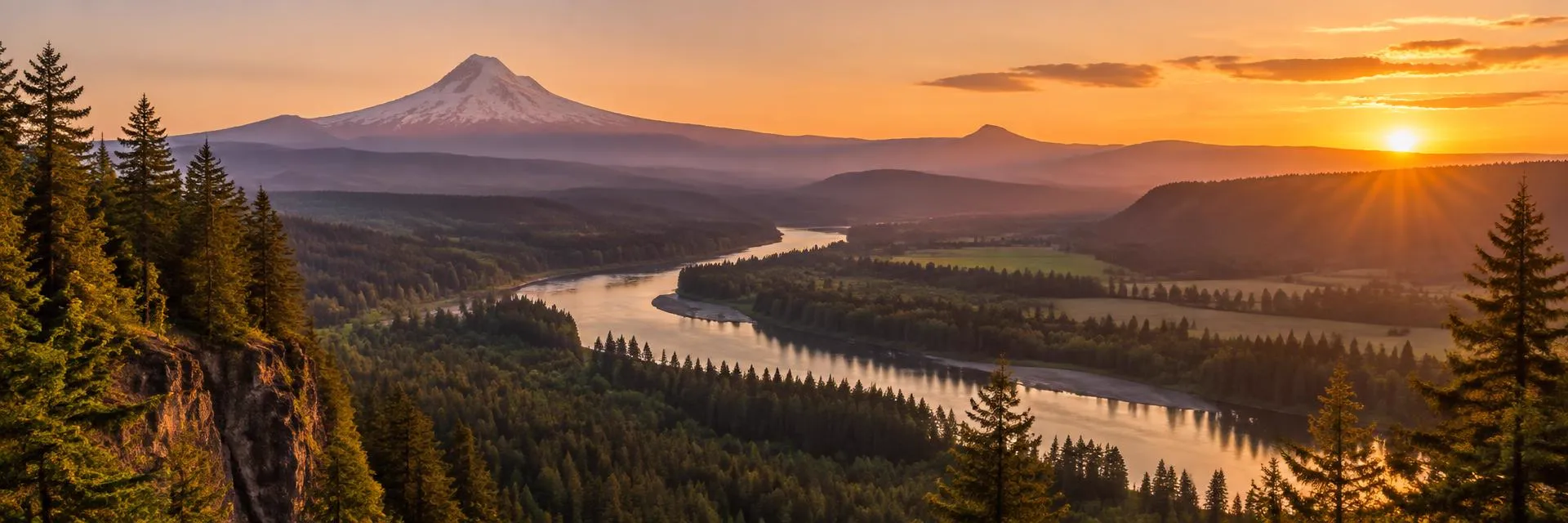 River winding through a forested Oregon valley at sunset